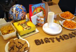 His own doggie-friendly birthday cake (with picture) from Lucies Farm, some of our doggie cookies --- and even some of our Haddock ice cream.