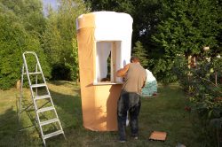 A pleasant August late afternoon, and Zbig is painting the canvas skin of our giant ice cream cone -- our booth at the 2006 Wag and Bone Show.